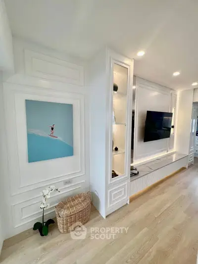 Modern living room with sleek TV setup and elegant wall decor