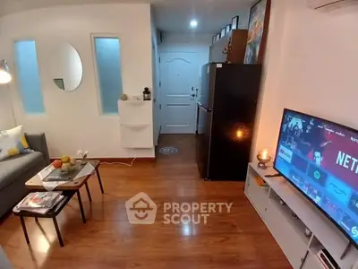 Cozy living room with modern decor and entertainment setup in a stylish apartment.