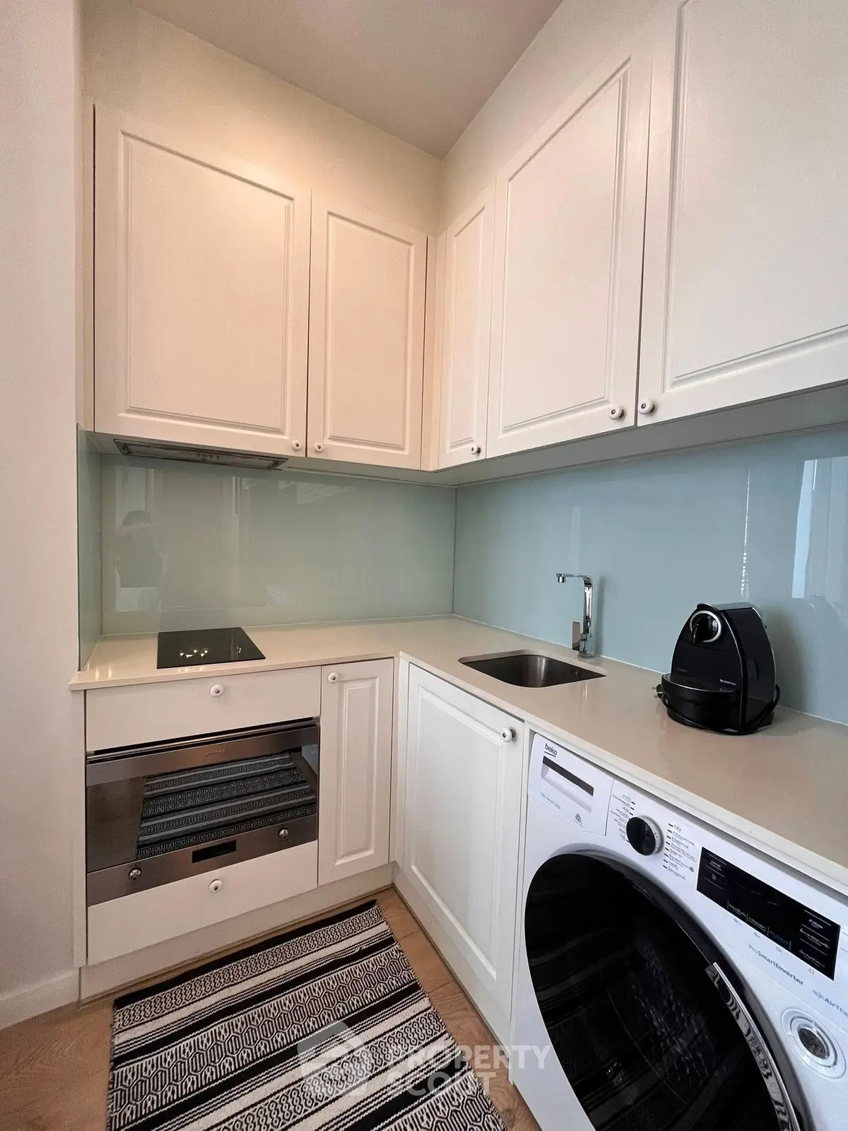 Modern kitchen with sleek white cabinets and built-in appliances