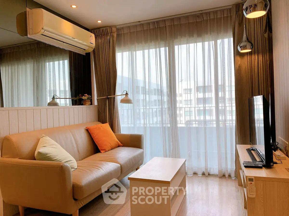 Modern living room with cozy sofa and natural light from large windows