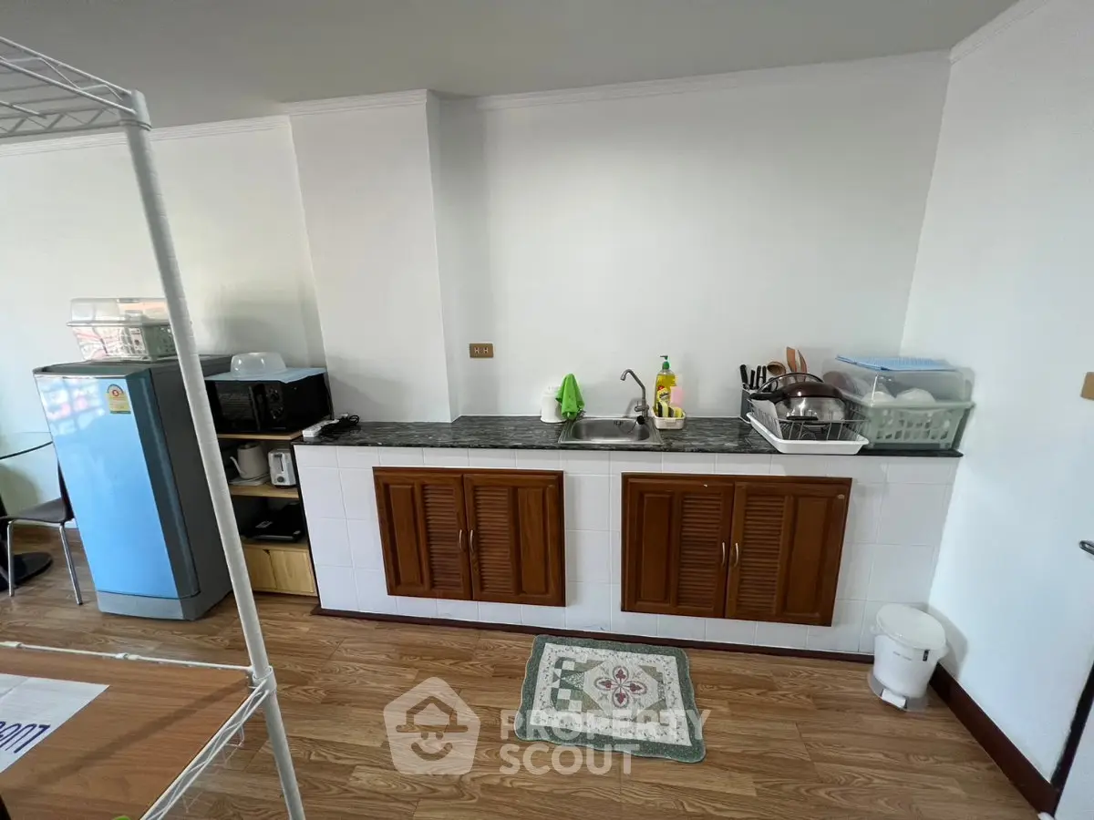 Charming kitchen with wooden cabinets and modern appliances, perfect for culinary enthusiasts.