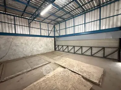 Spacious industrial warehouse with high ceilings and ample storage space.