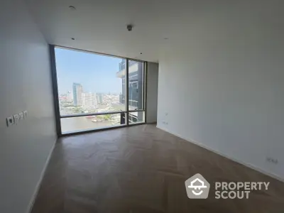 Spacious high-rise corner unit with large windows offering an abundance of natural light and a panoramic city view, featuring a generous balcony.