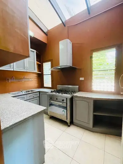 Charming kitchen with gas stove and ample natural light