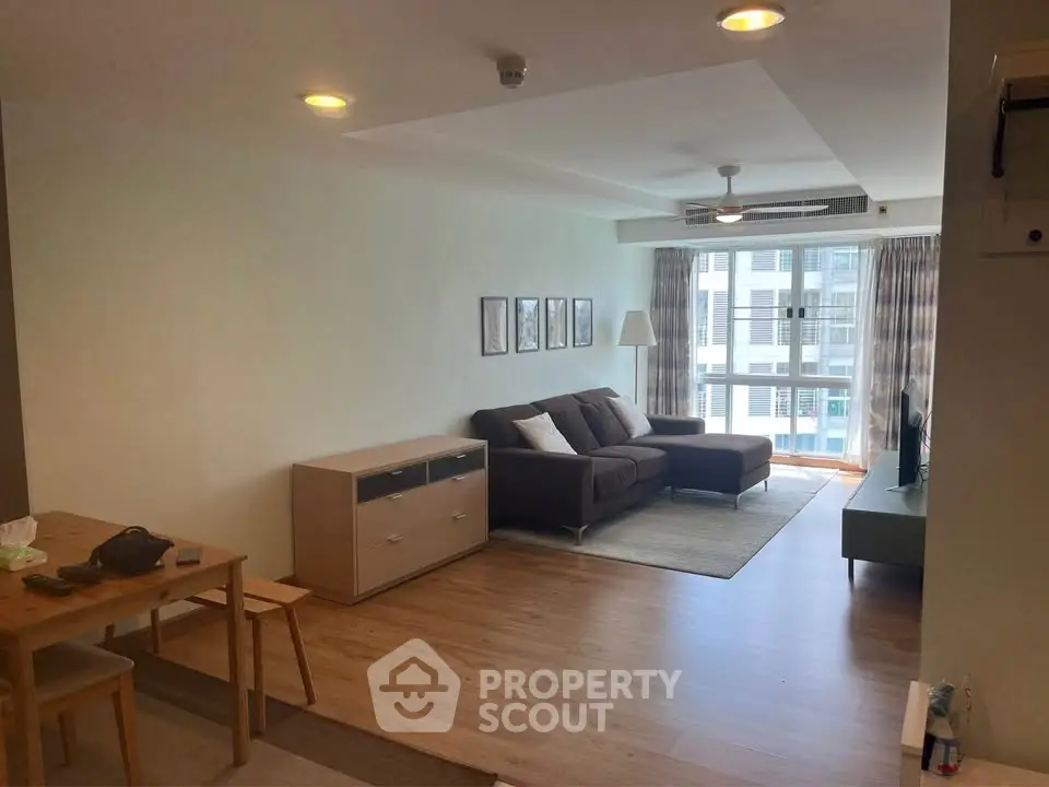 Spacious living room with modern decor and large windows offering natural light.