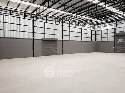 Spacious industrial warehouse with high ceilings and ample storage space.