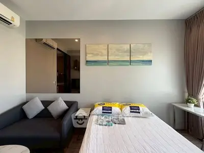 Modern studio apartment with cozy sofa and stylish wall art