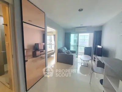 Modern living room with sleek design and balcony view in a high-rise apartment.