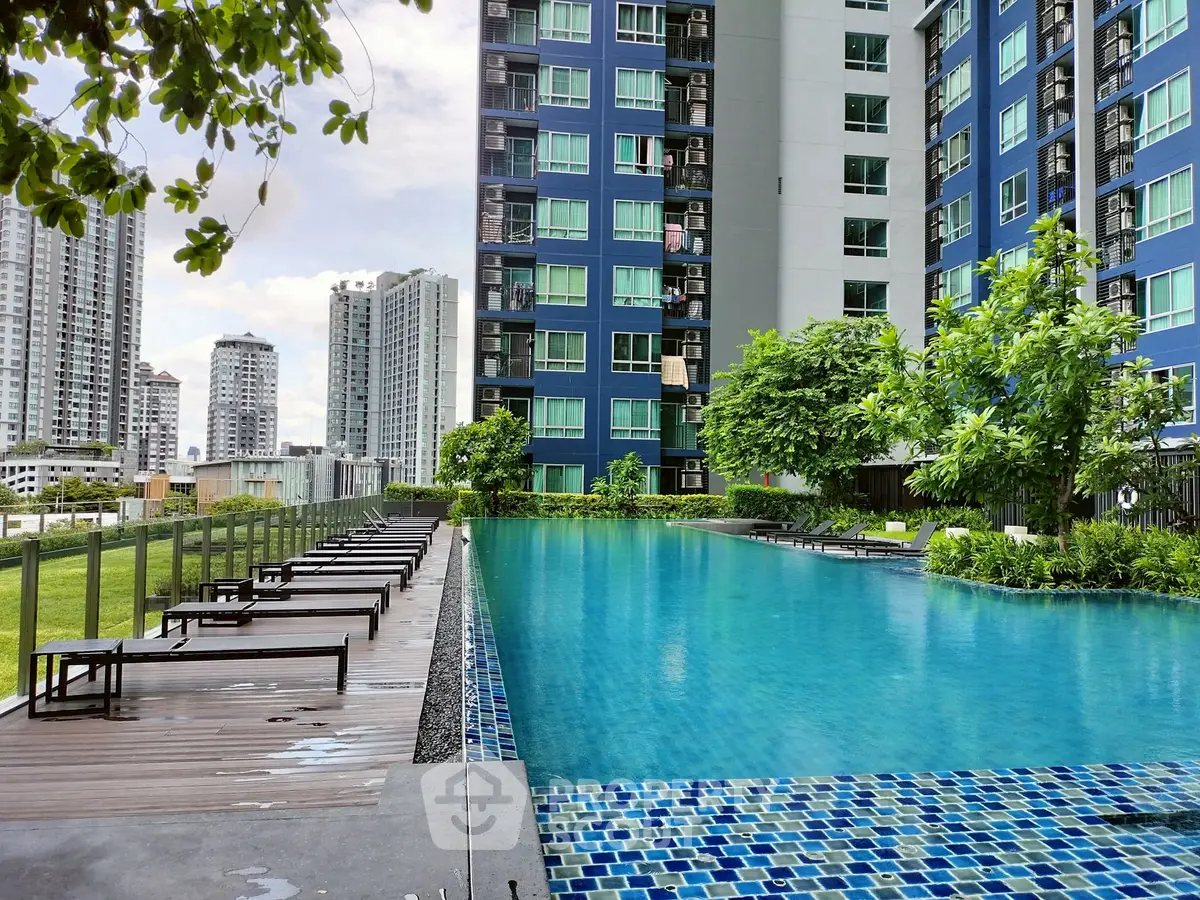 Luxurious urban apartment complex with stunning pool and city views.