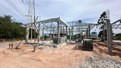 Under-construction modern building with steel framework and open surroundings