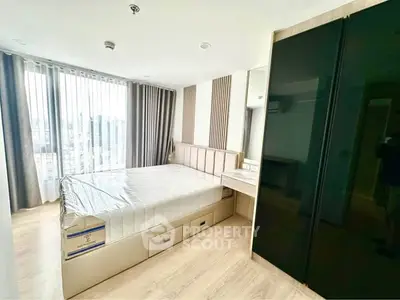 Modern bedroom with large window and sleek furnishings in a high-rise apartment.