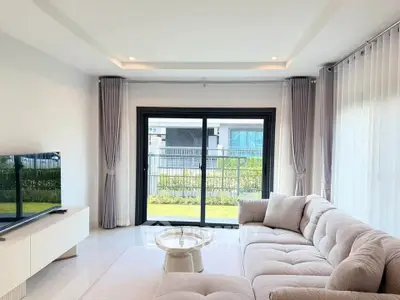 Modern living room with plush sofa and large window view