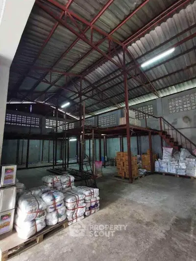 Spacious industrial warehouse with mezzanine and ample storage space.
