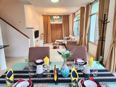 Spacious living and dining area with elegant decor and natural light