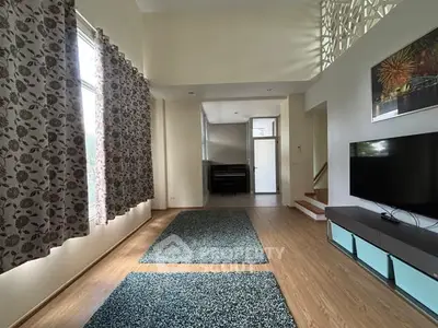 Spacious living room with modern decor and large windows