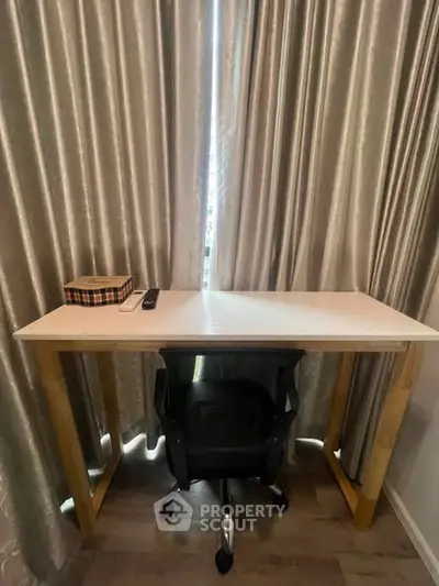 Modern study area with sleek desk and comfortable chair in a stylish apartment.