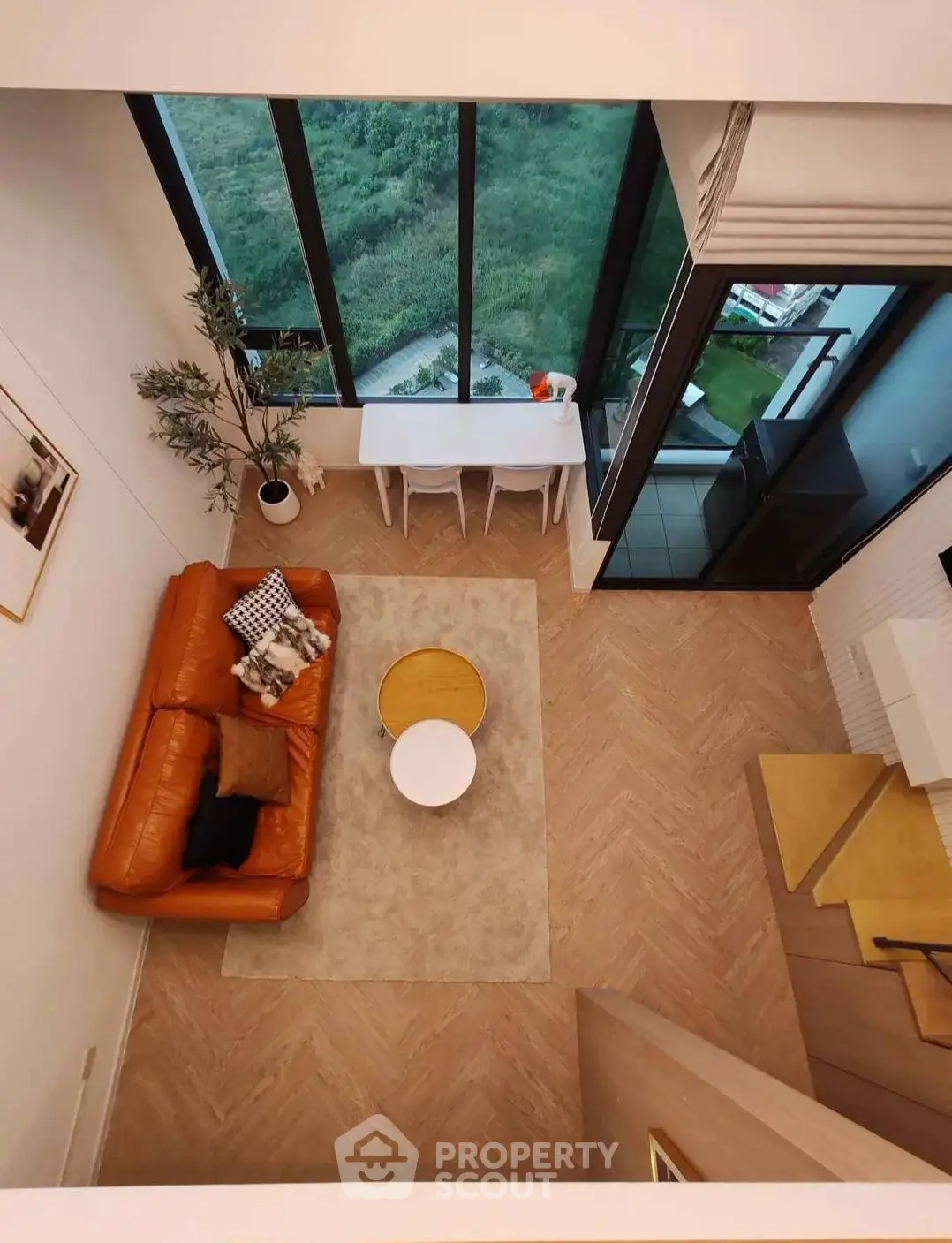 Modern living room with large windows and stylish furniture offering a stunning view.