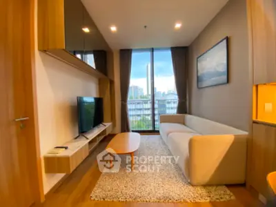 Modern living room with large window and stylish furniture in urban apartment.