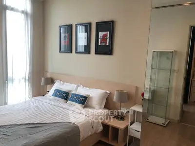 Modern bedroom with stylish decor and natural light, featuring a cozy bed and elegant furnishings.