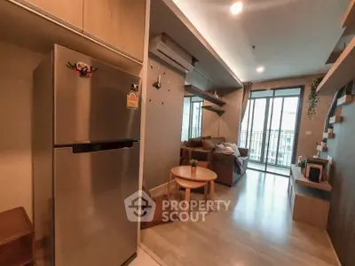 Modern living room with balcony and sleek kitchen appliances