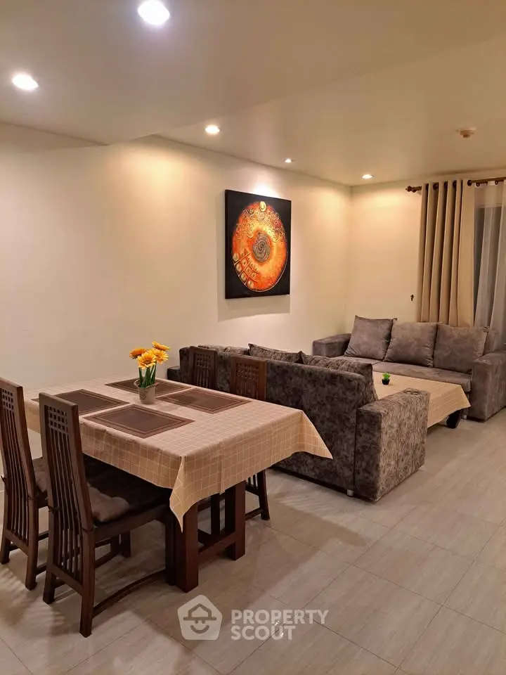 Spacious living room with elegant dining area and cozy seating, perfect for family gatherings.
