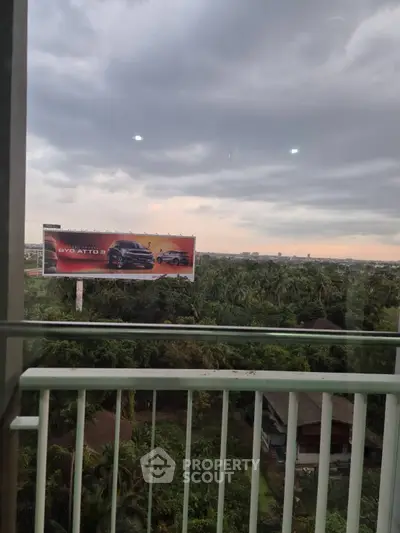 Scenic balcony view overlooking lush greenery and distant city skyline