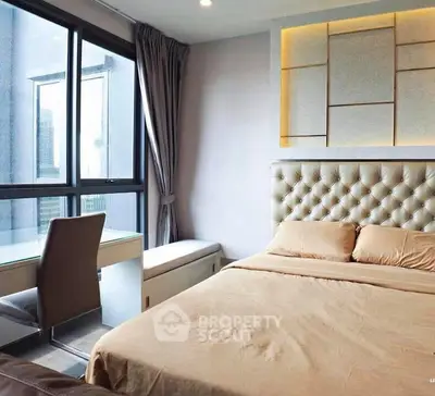 Modern bedroom with elegant decor and large windows for natural light.