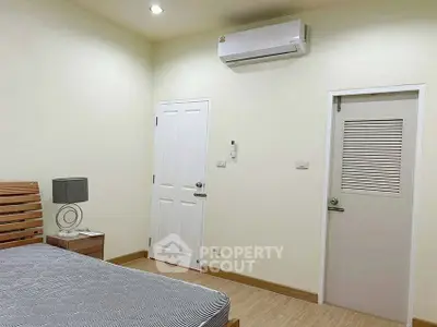Modern bedroom with air conditioning and minimalist decor