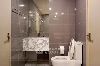 Modern bathroom with sleek design and marble accents in a contemporary apartment.