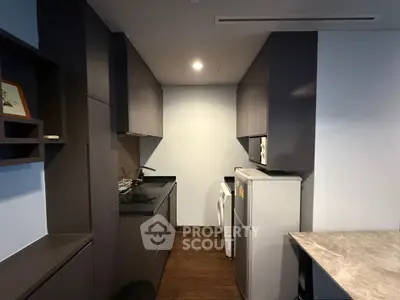 Modern compact kitchen with sleek cabinetry and appliances