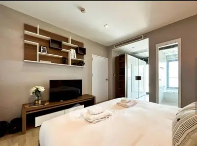 Modern bedroom with ensuite bathroom and stylish shelving unit