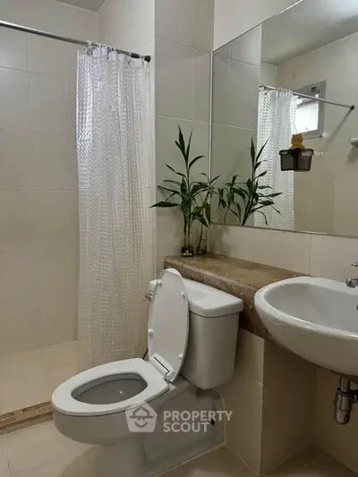 Modern bathroom with sleek fixtures and elegant decor, featuring a shower and stylish vanity.