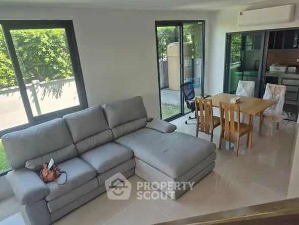 Spacious living room with modern furniture and large windows for natural light.