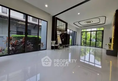 Spacious modern living room with large windows and garden view