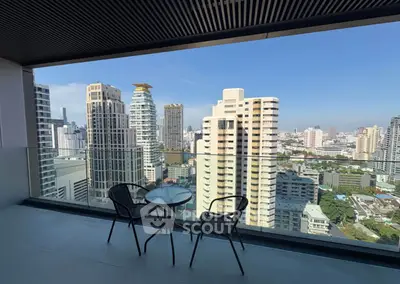 Stunning high-rise balcony with panoramic city view and modern seating area.