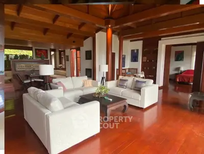 Luxurious open-plan living room with elegant wooden flooring and modern furniture