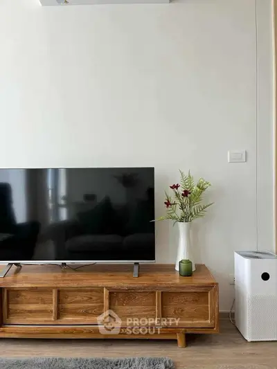 Modern living room with sleek TV stand, flat-screen TV, and stylish decor