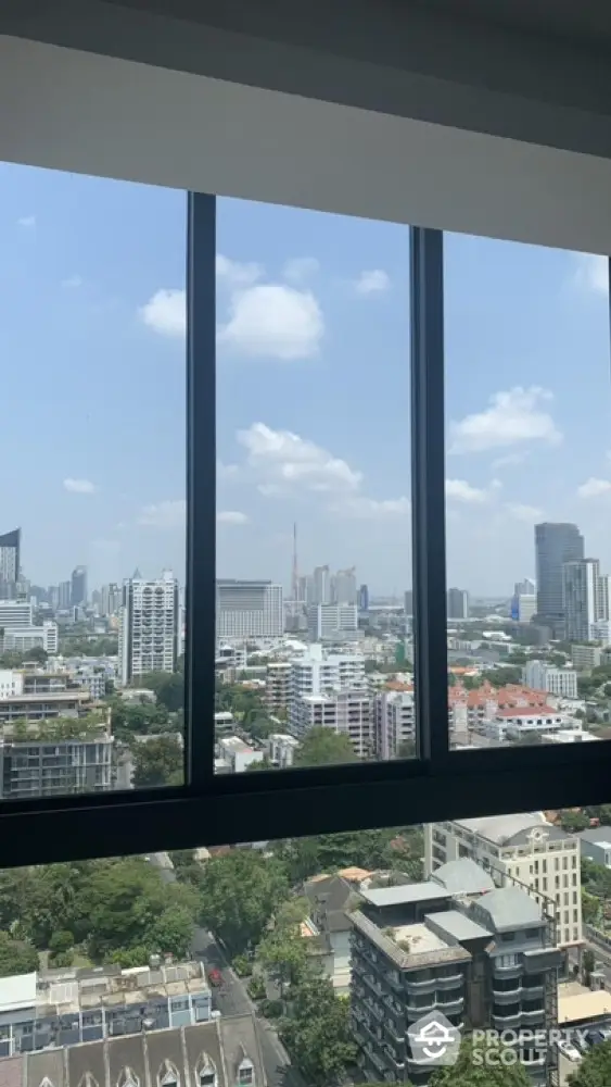 Stunning cityscape view from high-rise apartment window showcasing urban skyline.