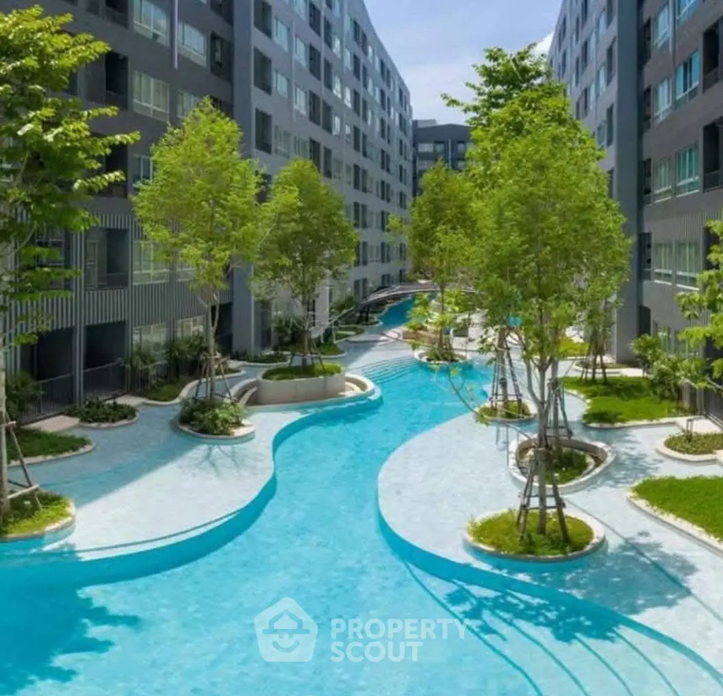 Luxurious apartment complex with stunning pool and lush greenery