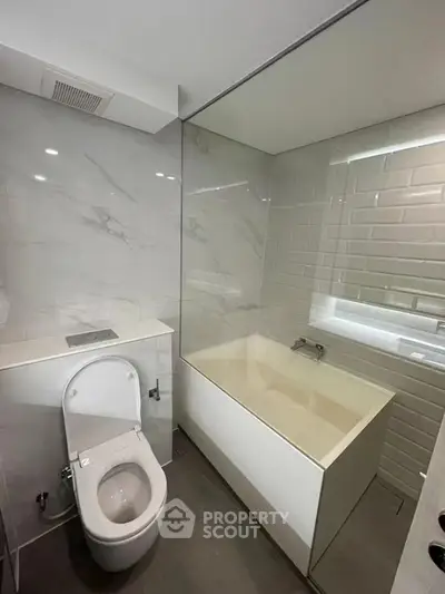 Modern bathroom with sleek design and bathtub in contemporary apartment