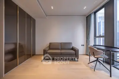 Modern living room with sleek sofa and large windows offering city views