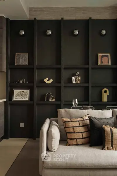 Stylish living room with modern decor and elegant shelving, featuring cozy sofa and artistic accents.