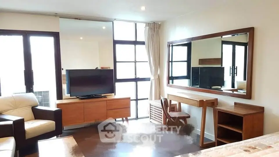 Spacious living room with modern furniture and large windows for natural light.