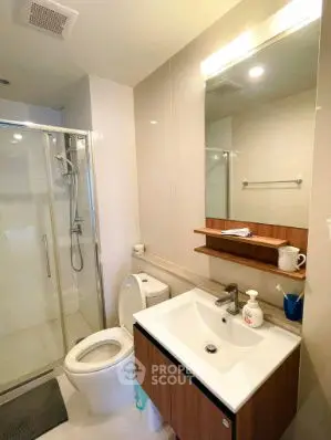 Modern bathroom with glass shower and sleek vanity