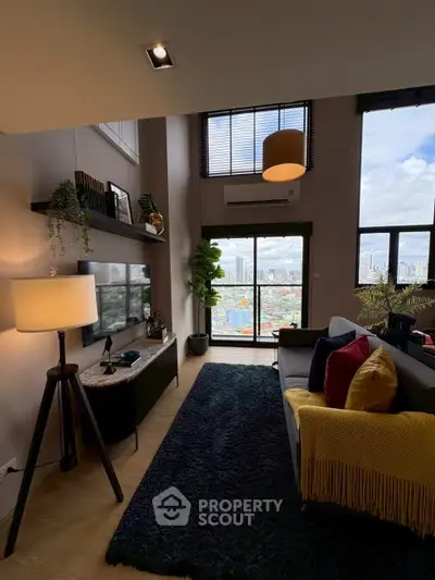 Stylish living room with city view, modern decor, and cozy ambiance in high-rise apartment.