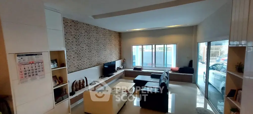 Spacious modern living room with stylish decor and large windows for natural light.