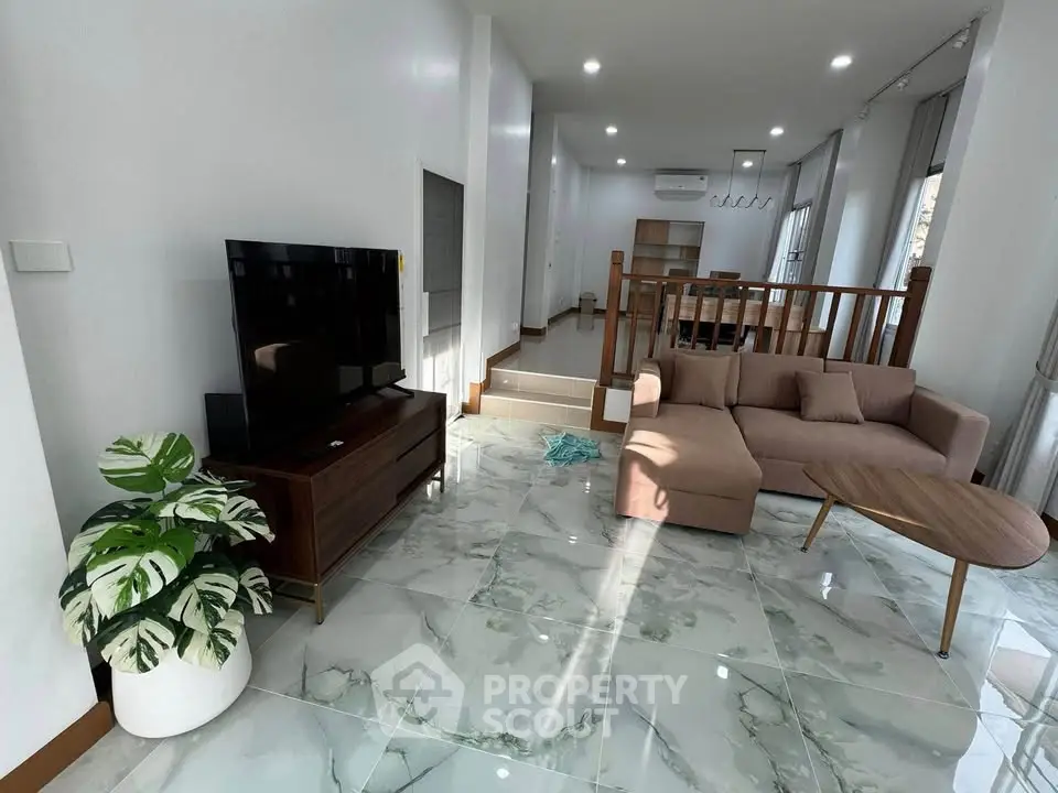 Modern living room with stylish furniture and elegant decor, featuring a cozy sofa and sleek TV stand.