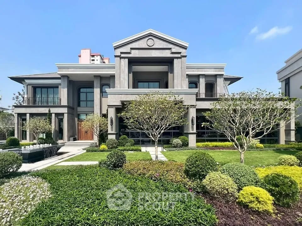 Luxurious modern mansion with manicured garden and grand facade