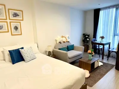 Cozy modern bedroom with stylish decor and comfortable seating area