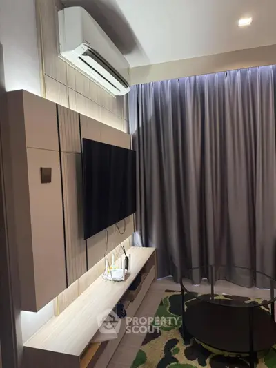 Modern living room with sleek TV setup and stylish air conditioning unit.